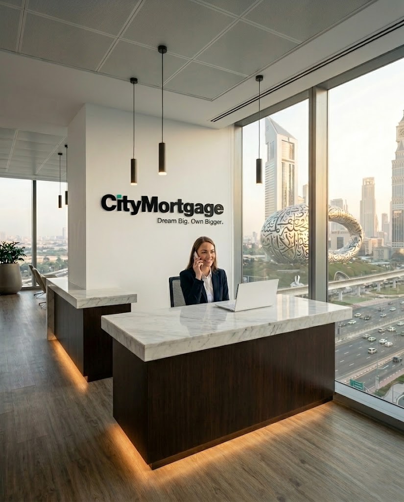City Mortgage advisor on phone in modern Dubai office with City Mortgage branding on wall — 20 years UAE mortgage expertise